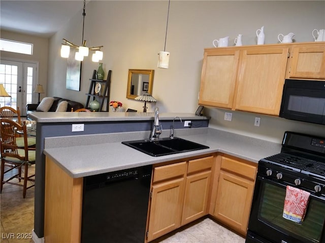9705 Templemore Ave Unit 102, Las Vegas, NV 89129 - kitchen featuring black appliances, a sink, light brown cabinets, a peninsula, and light countertops