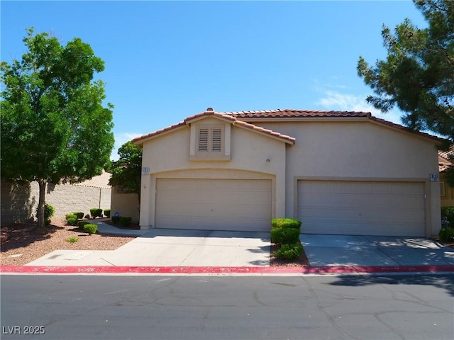 9705 Templemore Ave Unit 102, Las Vegas, NV 89129 - mediterranean / spanish house with stucco siding, a tile roof, concrete driveway, and an attached garage