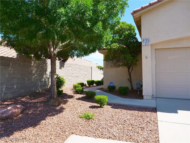 9705 Templemore Ave Unit 102, Las Vegas, NV 89129 - view of yard with a garage