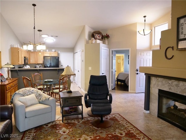 9705 Templemore Ave Unit 102, Las Vegas, NV 89129 - living room with lofted ceiling, a chandelier, light tile patterned floors, and a fireplace