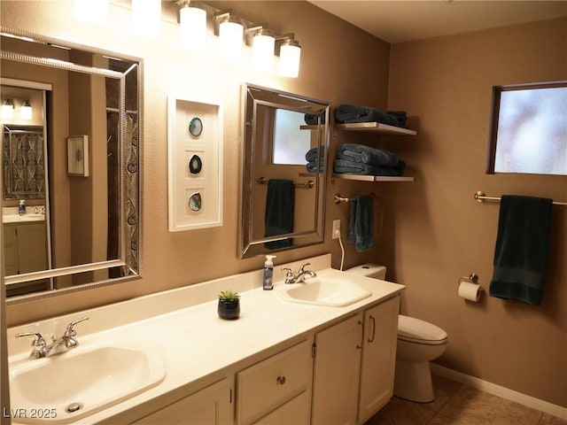 9705 Templemore Ave Unit 102, Las Vegas, NV 89129 - bathroom with toilet, double vanity, tile patterned floors, and baseboards