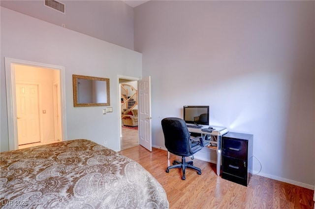 602 Painted Cloud Pl, Las Vegas, NV 89144 - bedroom with wood finished floors, baseboards, a high ceiling, and an office area
