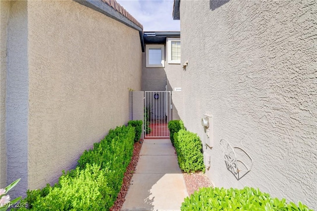 602 Painted Cloud Pl, Las Vegas, NV 89144 - view of exterior entry with stucco siding and a gate