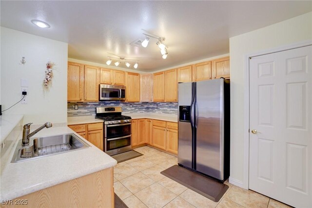602 Painted Cloud Pl, Las Vegas, NV 89144 - kitchen featuring appliances with stainless steel finishes, a sink, light brown cabinets, and tasteful backsplash