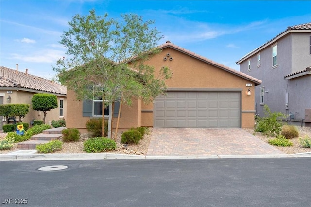 759 Star Apple Ln, Las Vegas, NV 89178 - mediterranean / spanish-style home featuring stucco siding, an attached garage, driveway, and a tiled roof