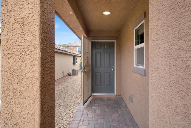759 Star Apple Ln, Las Vegas, NV 89178 - doorway to property featuring central AC unit and stucco siding