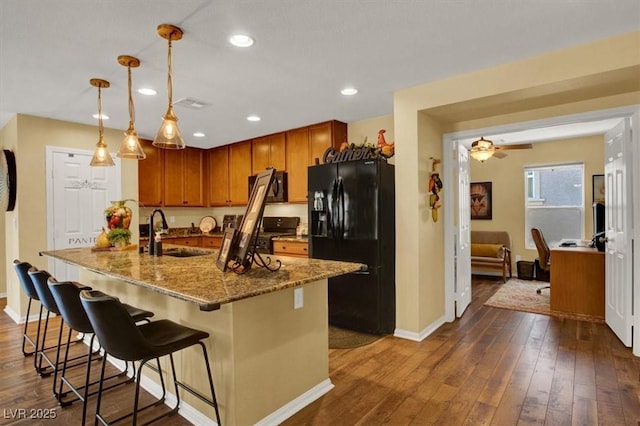 759 Star Apple Ln, Las Vegas, NV 89178 - kitchen with black appliances, a sink, baseboards, stone counters, and recessed lighting