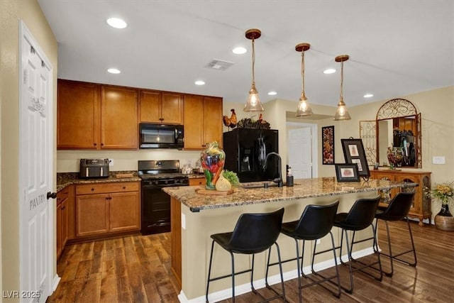 759 Star Apple Ln, Las Vegas, NV 89178 - kitchen featuring black appliances, a sink, dark wood-style floors, light stone countertops, and recessed lighting