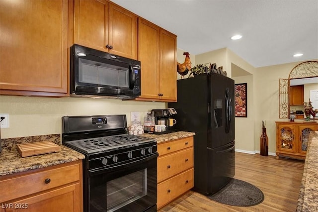 759 Star Apple Ln, Las Vegas, NV 89178 - kitchen with black appliances, light wood-type flooring, baseboards, light stone countertops, and recessed lighting