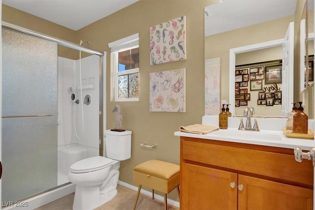 759 Star Apple Ln, Las Vegas, NV 89178 - bathroom featuring toilet, a stall shower, vanity, baseboards, and tile patterned flooring