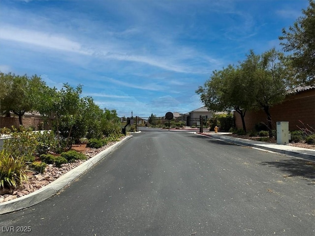 759 Star Apple Ln, Las Vegas, NV 89178 - view of asphalt street with curbs, a gated entry, and a gate
