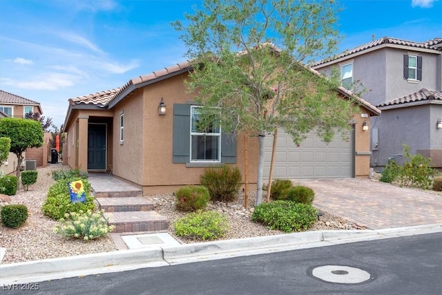 759 Star Apple Ln, Las Vegas, NV 89178 - mediterranean / spanish home featuring driveway, a tiled roof, stucco siding, central air condition unit, and a garage