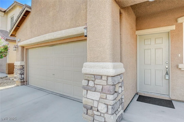 7963 Cape Brett St, Las Vegas, NV 89131 - view of exterior entry with stucco siding and concrete driveway
