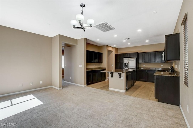7963 Cape Brett St, Las Vegas, NV 89131 - kitchen featuring a chandelier, stainless steel appliances, light colored carpet, a breakfast bar area, and hanging light fixtures