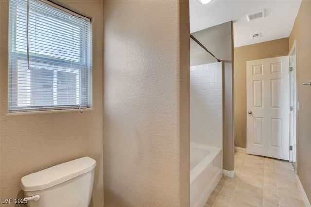 7963 Cape Brett St, Las Vegas, NV 89131 - bathroom featuring toilet, shower / bath combination, tile patterned floors, baseboards, and a textured wall