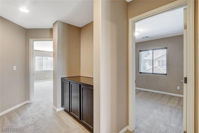 7963 Cape Brett St, Las Vegas, NV 89131 - corridor featuring light carpet, baseboards, and healthy amount of natural light