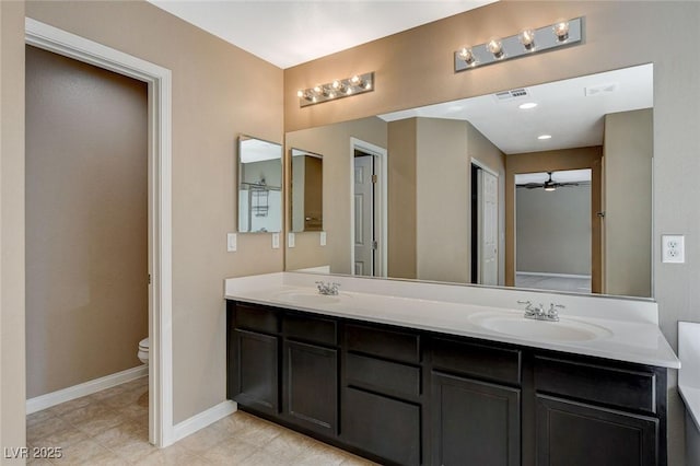 7963 Cape Brett St, Las Vegas, NV 89131 - full bathroom with toilet, double vanity, baseboards, tile patterned floors, and a ceiling fan