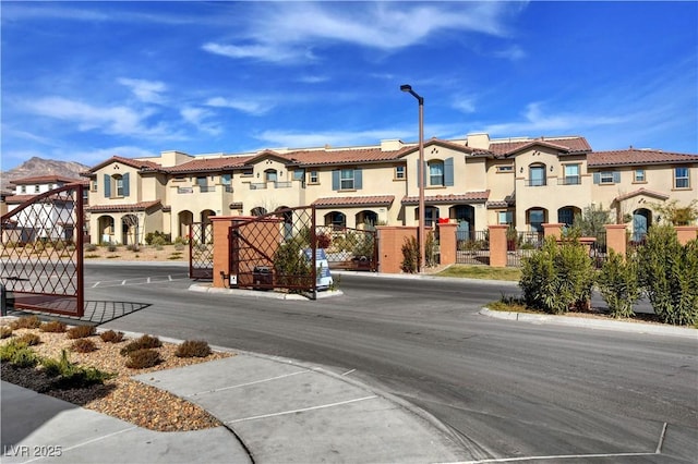 4 Lomita Heights Dr, Las Vegas, NV 89138 - view of asphalt road with a gate, a residential view, street lighting, and a gated entry
