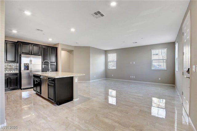 4 Lomita Heights Dr, Las Vegas, NV 89138 - kitchen with stainless steel appliances, a sink, an island with sink, tasteful backsplash, and baseboards