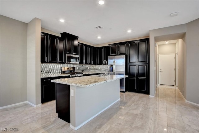 4 Lomita Heights Dr, Las Vegas, NV 89138 - kitchen featuring stainless steel appliances, dark cabinets, a sink, baseboards, and tasteful backsplash