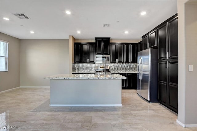 4 Lomita Heights Dr, Las Vegas, NV 89138 - kitchen with appliances with stainless steel finishes, dark cabinets, decorative backsplash, light stone counters, and recessed lighting