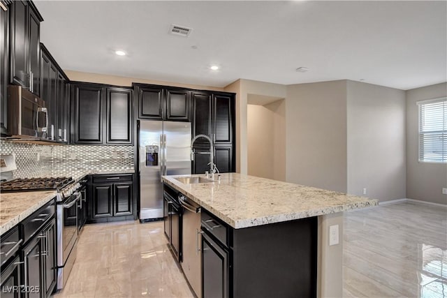 4 Lomita Heights Dr, Las Vegas, NV 89138 - kitchen with appliances with stainless steel finishes, dark cabinets, a center island with sink, and recessed lighting