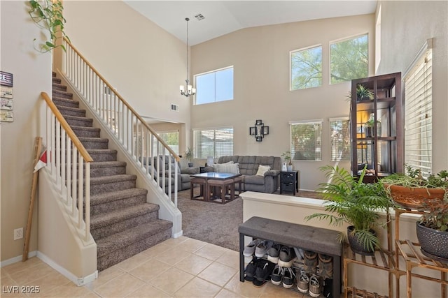 1906 Desert Sage Ave, North Las Vegas, NV 89031 - living area with light tile patterned floors, stairs, light carpet, high vaulted ceiling, and a chandelier