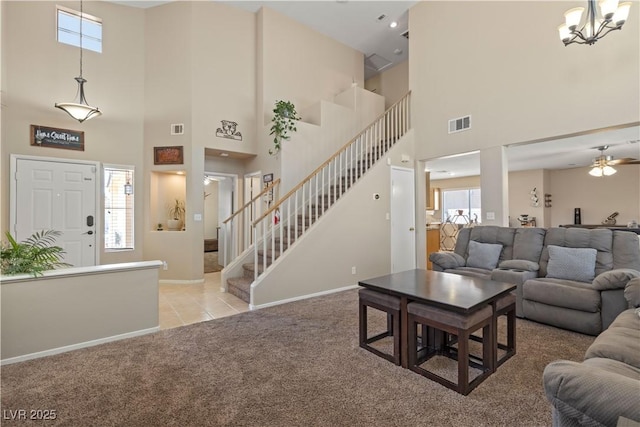 1906 Desert Sage Ave, North Las Vegas, NV 89031 - carpeted living room with a high ceiling, stairway, plenty of natural light, tile patterned floors, and a chandelier