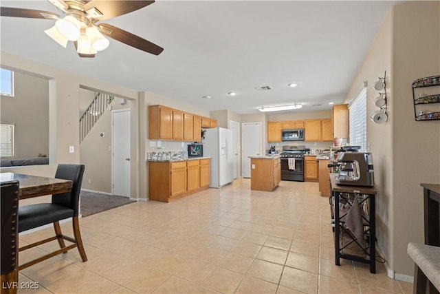 1906 Desert Sage Ave, North Las Vegas, NV 89031 - kitchen with stainless steel appliances, light countertops, open floor plan, a center island, and light tile patterned floors