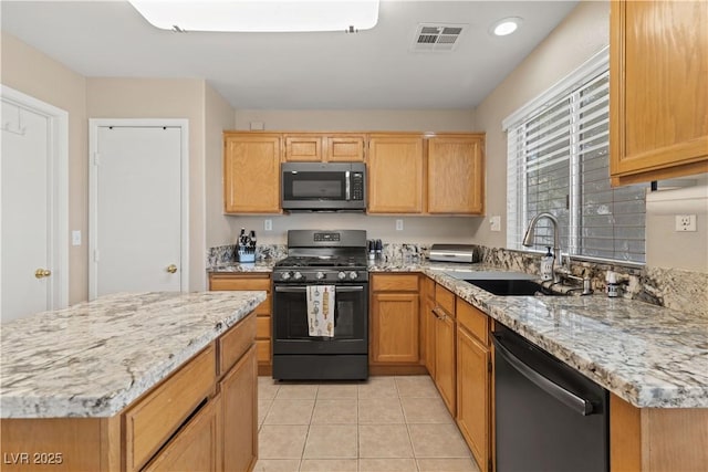 1906 Desert Sage Ave, North Las Vegas, NV 89031 - kitchen featuring stainless steel microwave, range with gas stovetop, dishwashing machine, light stone counters, and light tile patterned floors