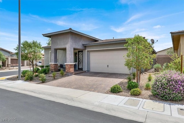 676 Otter Brook St, Henderson, NV 89011 - view of front of property with stucco siding, a garage, driveway, and a porch