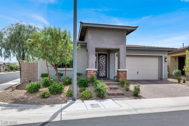 676 Otter Brook St, Henderson, NV 89011 - view of front of house featuring stucco siding, an attached garage, and driveway