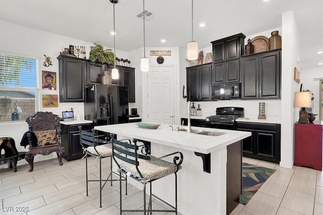 676 Otter Brook St, Henderson, NV 89011 - kitchen with black appliances, a sink, dark cabinetry, decorative light fixtures, and recessed lighting