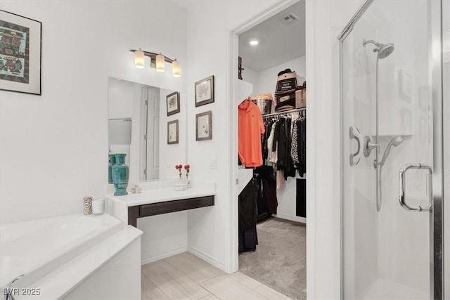 676 Otter Brook St, Henderson, NV 89011 - bathroom featuring a shower stall, a spacious closet, a bath, tile patterned floors, and baseboards
