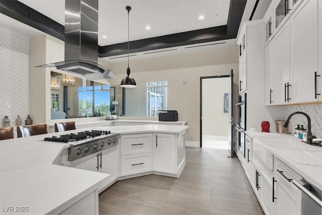 676 Otter Brook St, Henderson, NV 89011 - kitchen with appliances with stainless steel finishes, island exhaust hood, decorative backsplash, a sink, and white cabinetry