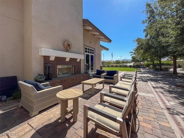 676 Otter Brook St, Henderson, NV 89011 - view of patio / terrace with an outdoor living space with a fireplace