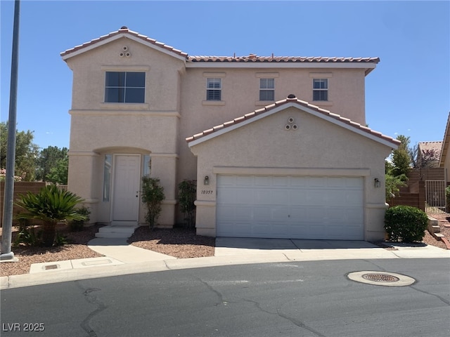 10357 Bent Willow Ave, Las Vegas, NV 89129 - mediterranean / spanish house featuring stucco siding, a tile roof, and driveway
