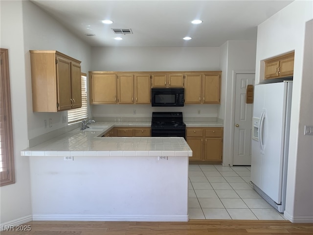 10357 Bent Willow Ave, Las Vegas, NV 89129 - kitchen featuring black appliances, a peninsula, a sink, tile countertops, and recessed lighting