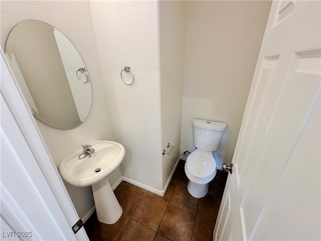 7815 Shingle Beach St, Las Vegas, NV 89166 - bathroom featuring tile patterned floors, toilet, and baseboards