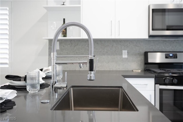 10532 Redwood Ash Ave, Las Vegas, NV 89144 - kitchen featuring appliances with stainless steel finishes, white cabinetry, and backsplash