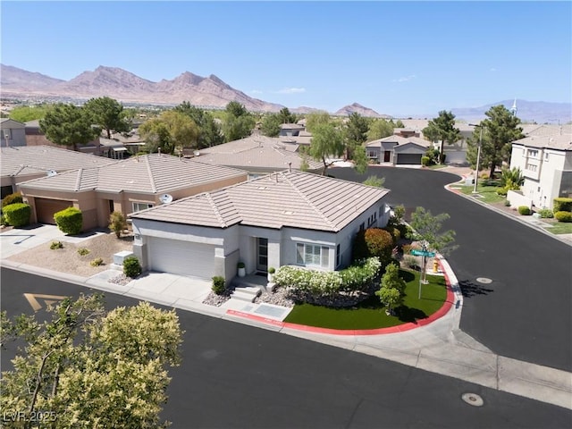 10532 Redwood Ash Ave, Las Vegas, NV 89144 - view of front of house featuring an attached garage, stucco siding, a residential view, a mountain view, and a tiled roof