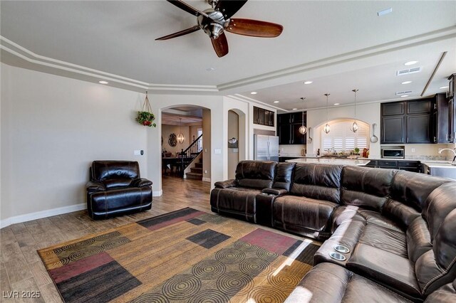 6403 Brandon Hills Ct, Las Vegas, NV 89139 - living area with arched walkways, ceiling fan, wood finished floors, baseboards, and recessed lighting