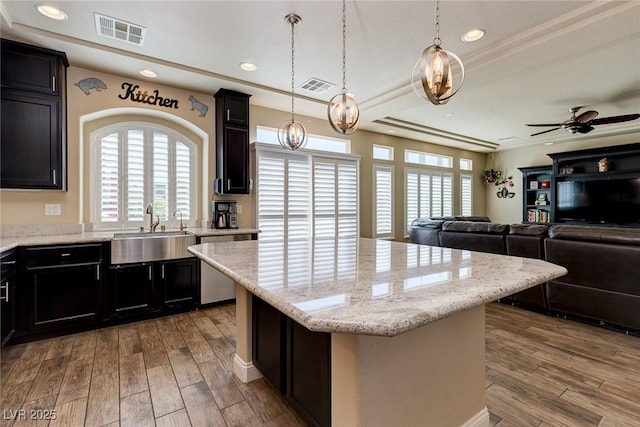 6403 Brandon Hills Ct, Las Vegas, NV 89139 - kitchen with a sink, dishwasher, wood finished floors, a center island, and a ceiling fan