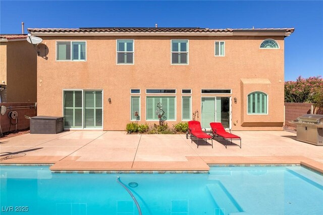 6403 Brandon Hills Ct, Las Vegas, NV 89139 - rear view of property featuring stucco siding, an outdoor pool, and a patio area