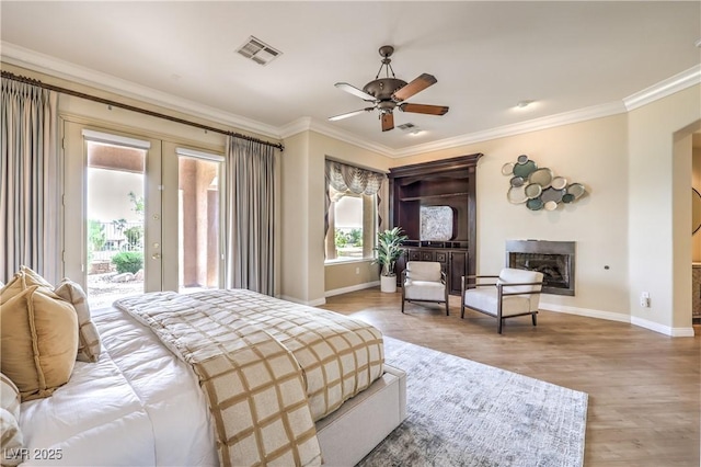 5162 Estasi St, Las Vegas, NV 89135 - bedroom featuring access to outside, baseboards, wood finished floors, ornamental molding, and a fireplace
