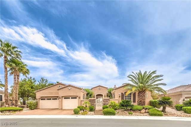 5162 Estasi St, Las Vegas, NV 89135 - mediterranean / spanish home with driveway, stucco siding, and a garage