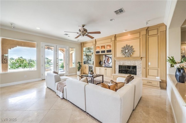 5162 Estasi St, Las Vegas, NV 89135 - living room with ceiling fan, a fireplace, ornamental molding, baseboards, and light tile patterned floors