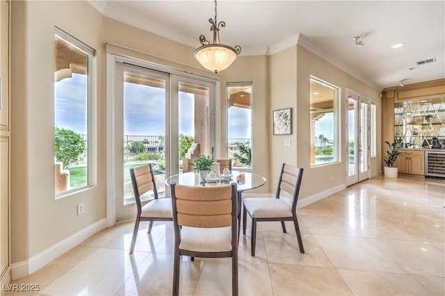 5162 Estasi St, Las Vegas, NV 89135 - dining room featuring healthy amount of natural light, ornamental molding, baseboards, light tile patterned floors, and wine cooler