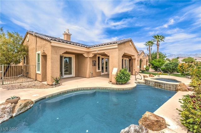 5162 Estasi St, Las Vegas, NV 89135 - back of property featuring stucco siding, a tiled roof, a chimney, a patio area, and a pool with connected hot tub
