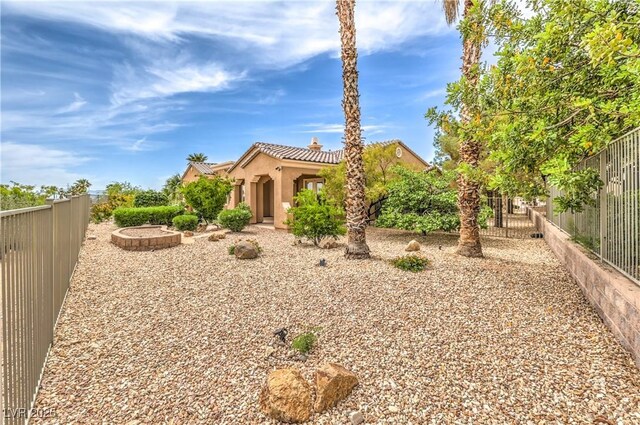 5162 Estasi St, Las Vegas, NV 89135 - view of front of home with a tiled roof, a fenced backyard, stucco siding, and a chimney